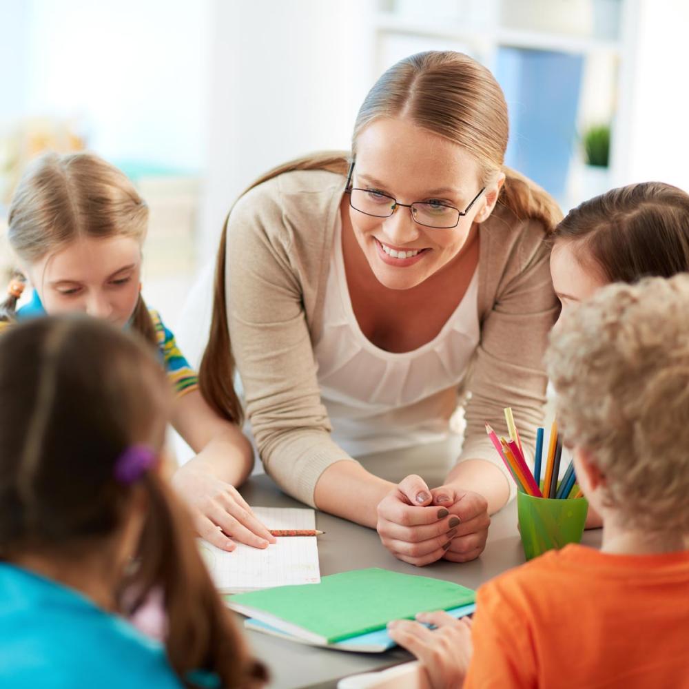 Preschool educator listening to students
